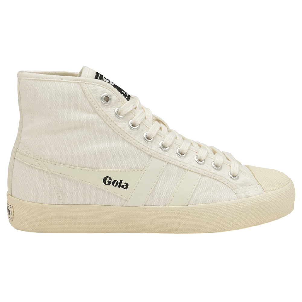 A classic white Gola plimsoll high-top, pictured from the side. It has white fabric uppers and a thick sole, with off-white tones contrasting against the white laces. Gola's logo sits along the wingflash with black lettering, standing out stylishly.