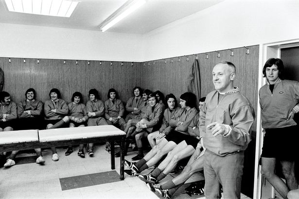 Bill Shankly and his Liverpool football team wearing Gola football boots in the changing rooms