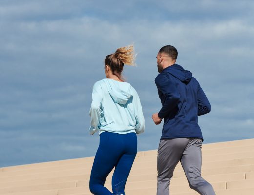 Man and woman running in the sun in Gola Perforamnce trainers